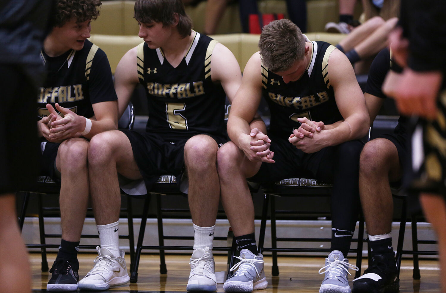 Buffalo's starters hold hands on the bench